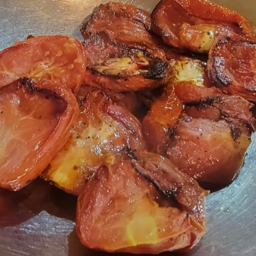finished roasted tomatoes shown in mixing bowl