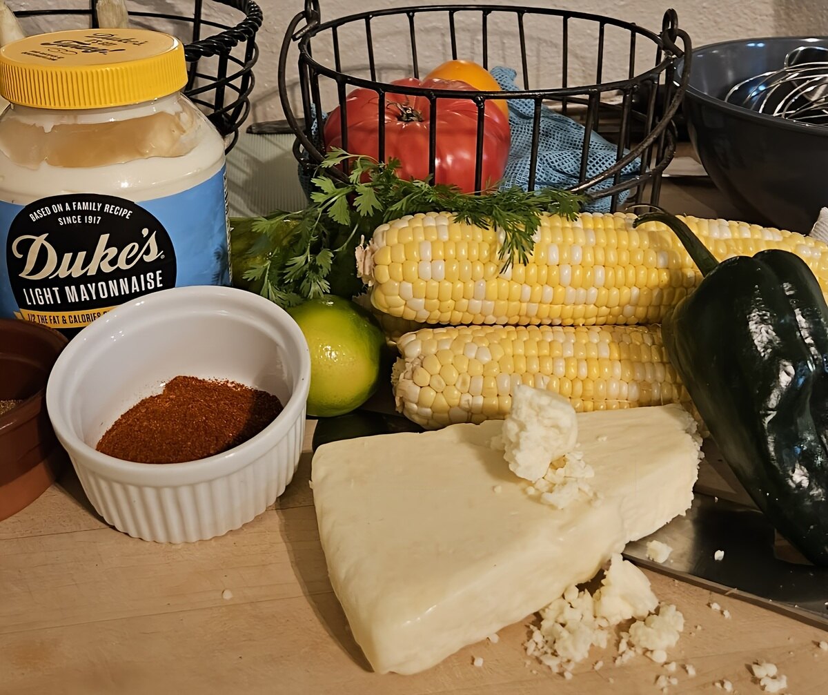 ingredients for Mexican street corn quinoa. Corn on the cob, poblanos, cotija cheese, lime, chili powder, mayonnaise, cilantro.