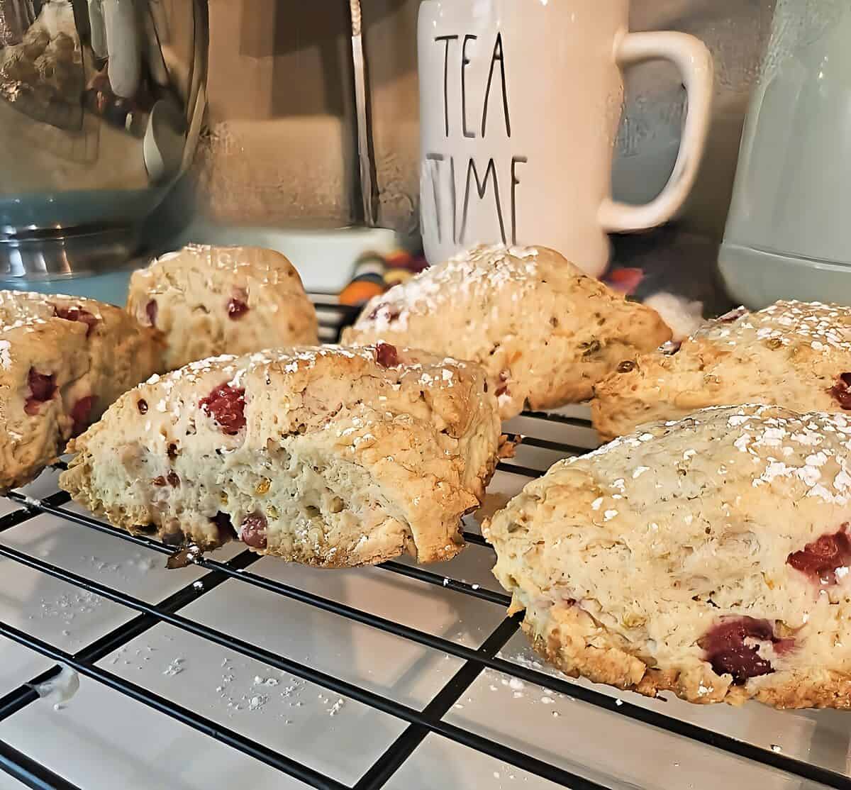 baked scones with powdered sugar garnish, on cooling rack