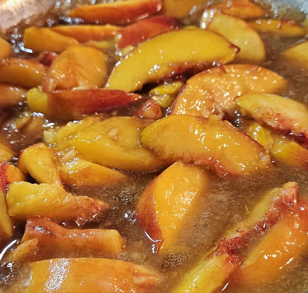 peaches and syrup cooking in sauté pan