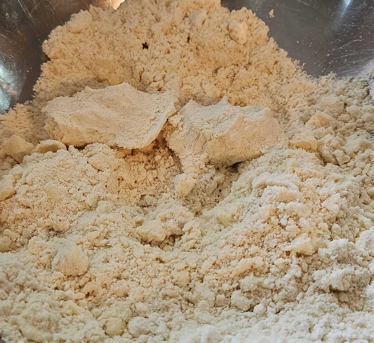 mixture of dry cobbler crust ingredients with softened butter worked in, the consistency of wet sand