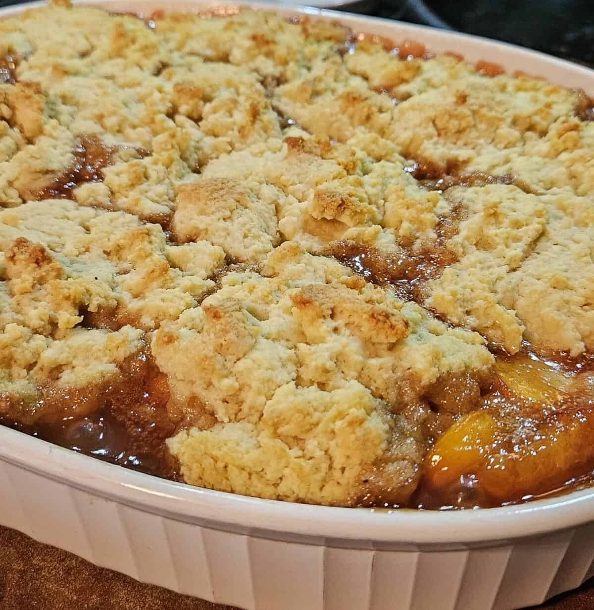 finished, fully cooked peach cobbler in baking pan