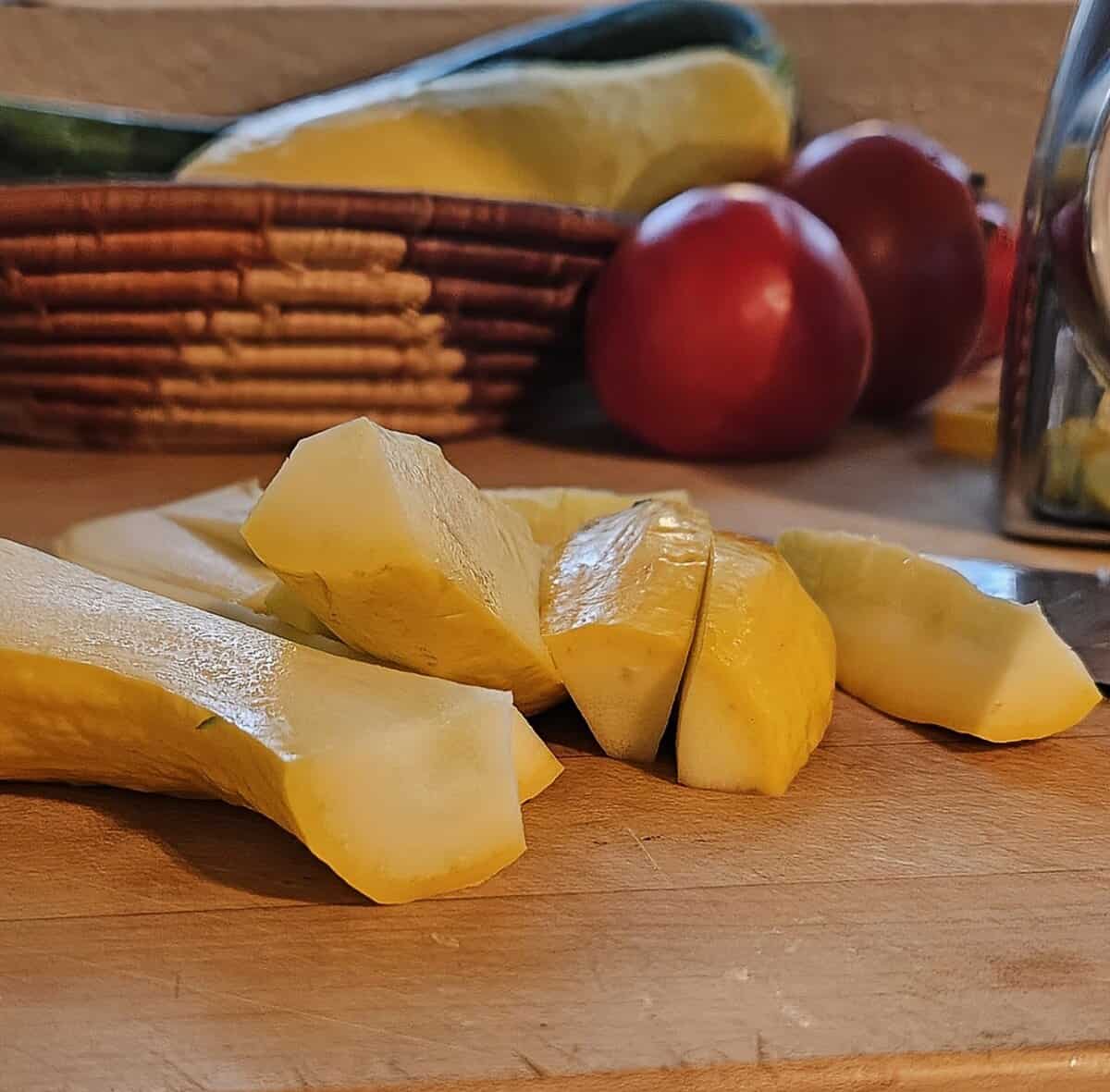 long sliced yellow squash on a cutting board