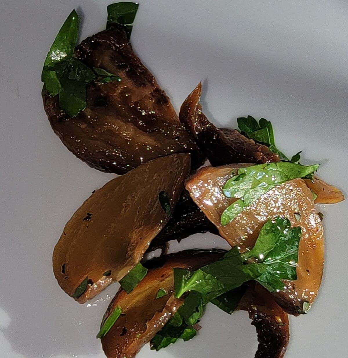 seasoned and smoked beet pieces laying on a plate.