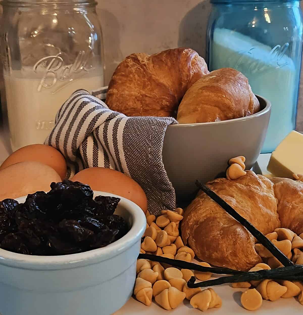 ingredients for bread pudding, croissants, butterscotch chips, vanilla beans, eggs, milk, sugar, butter