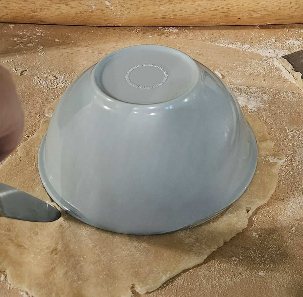 small plastic bowl inverted onto pie crust to use as a cutting guide for round pieces