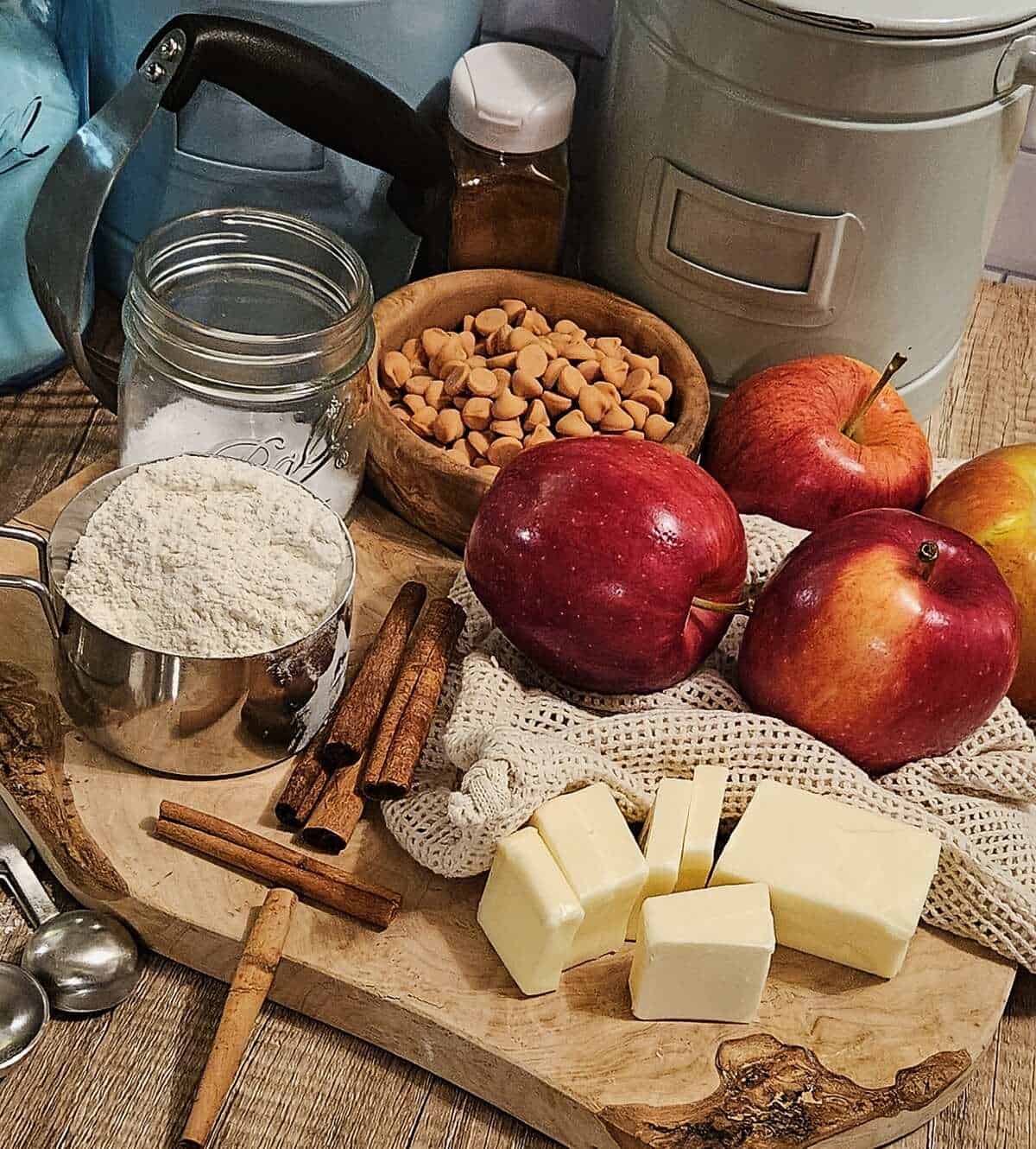 ingredients for caramel apple empanadas; butter, cinnamon, flour, sugar, caramel chips, apples