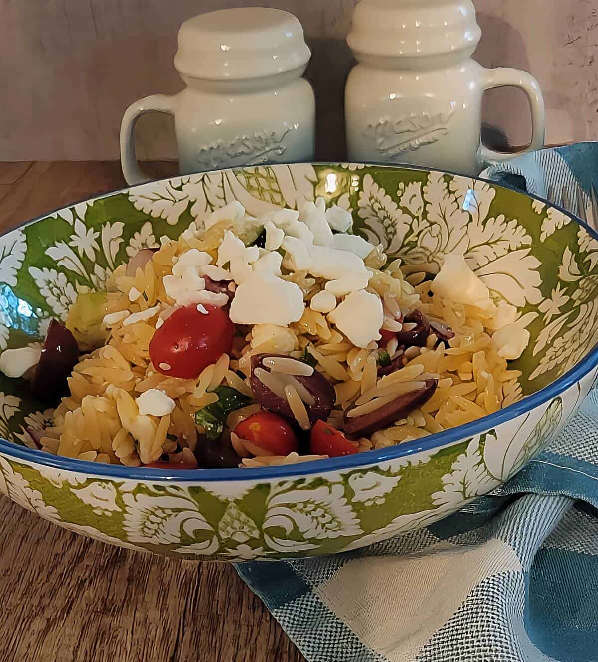 finished Greek orzo pasta in a bowl topped with feta cheese