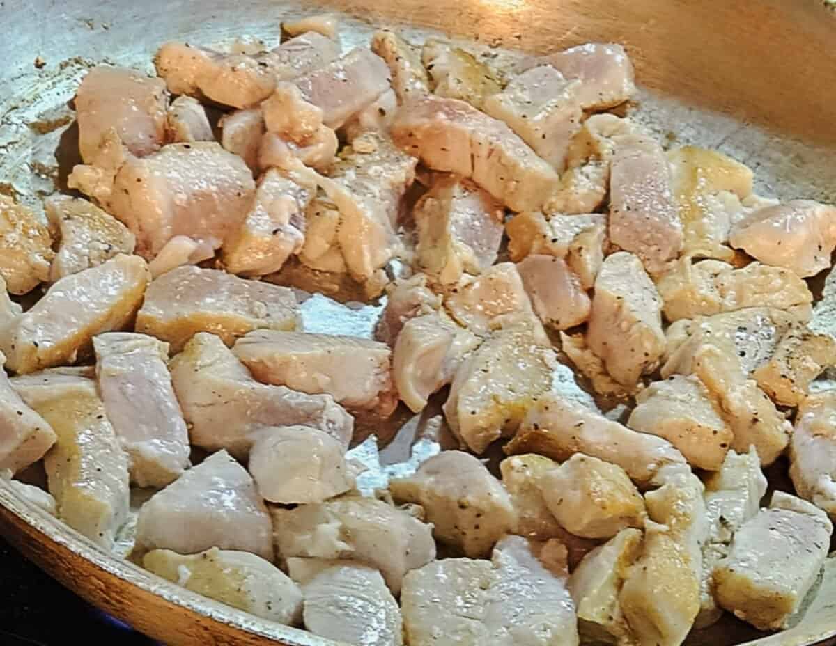 chicken breast pieces in a skillet, turned t present the browned side.