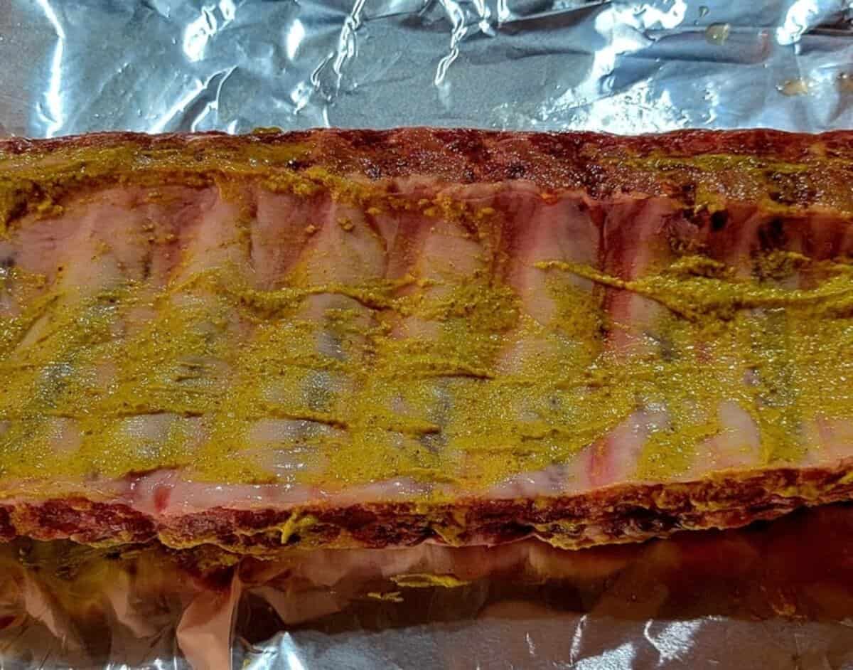 back side of ribs coated with mustard