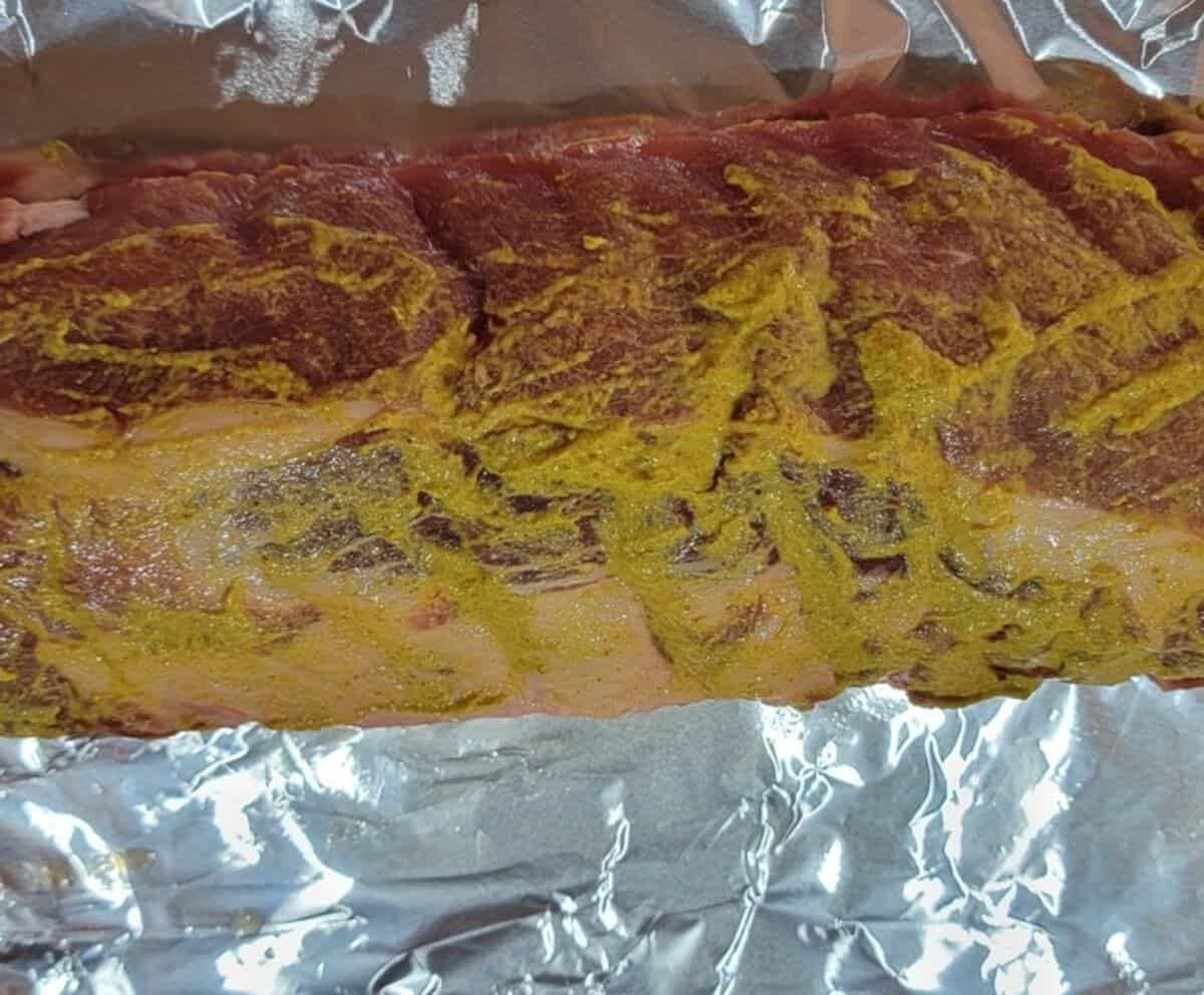 top side of rib rack coated in mustard