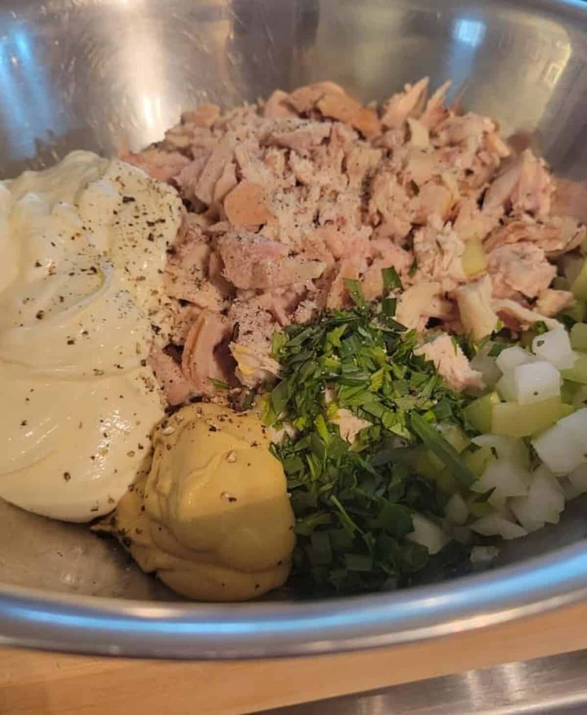 chicken salad ingredients; mayonnaise, chopped cooked chicken, diced onion and celery, chopped fresh tarragon, dijon mustard, salt and pepper