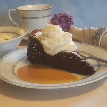 plated chocolate torte with caramel sauce and whipped cream