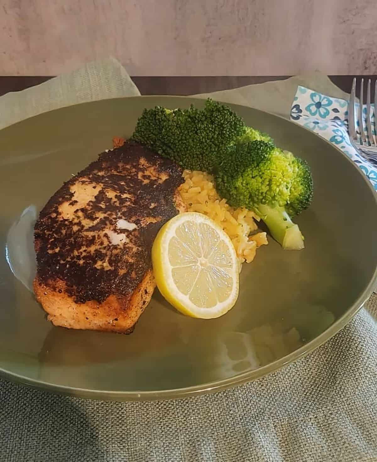 plated dijon rosemary salmon, with rice, broccoli, and lemon slice garnish