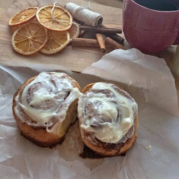 giant cinnamon rolls finished with icing, served with a cup of coffee