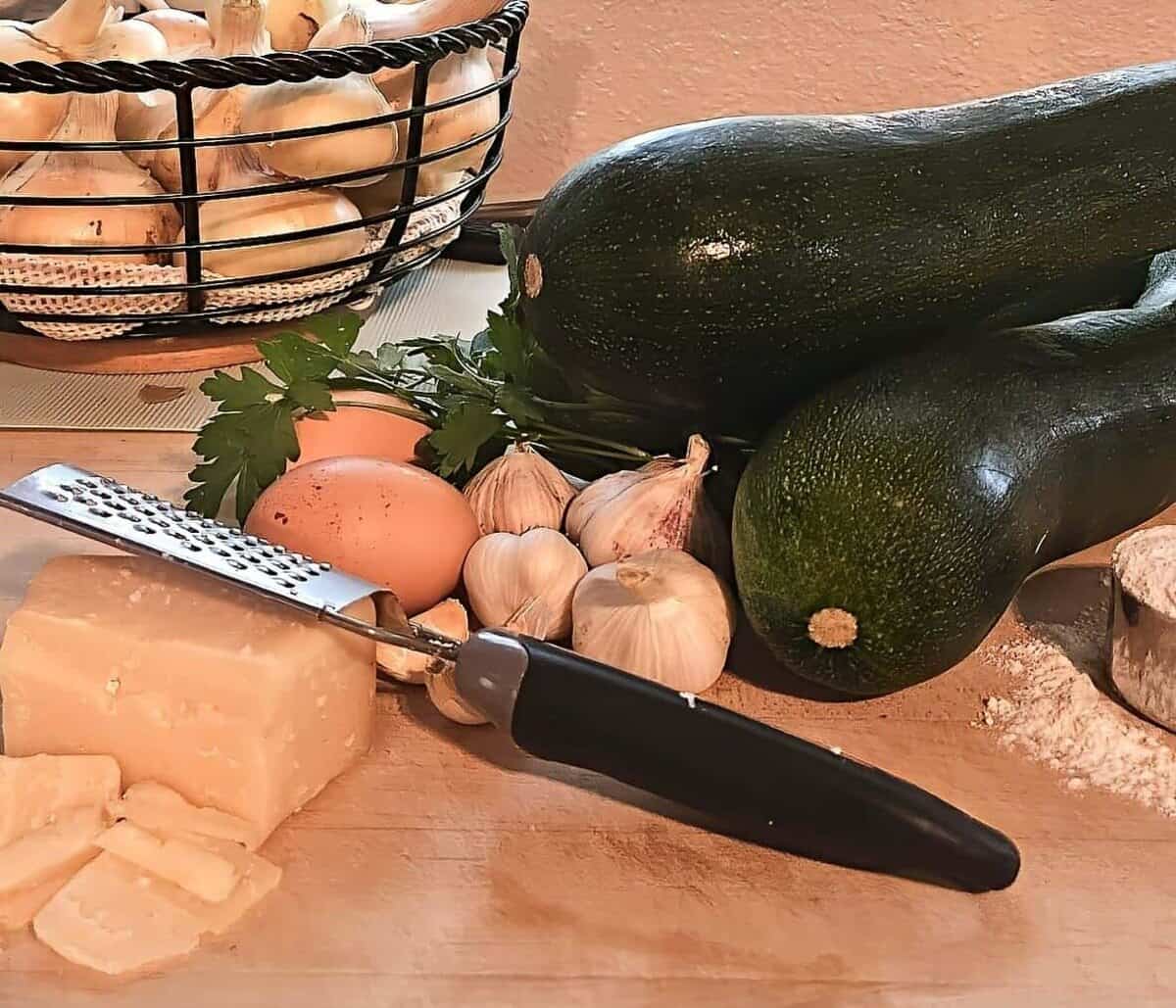 zucchini bread ingredients; parmesan cheese, eggs, garlic, parsley, zucchini, flour, onions