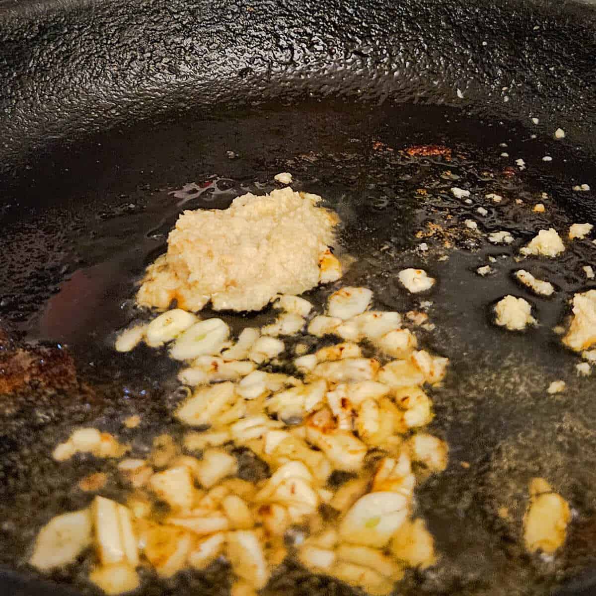 chopped garlic and ginger cooking a pan for the cast iron seared pork tenderloin with tangerine ginger sauce