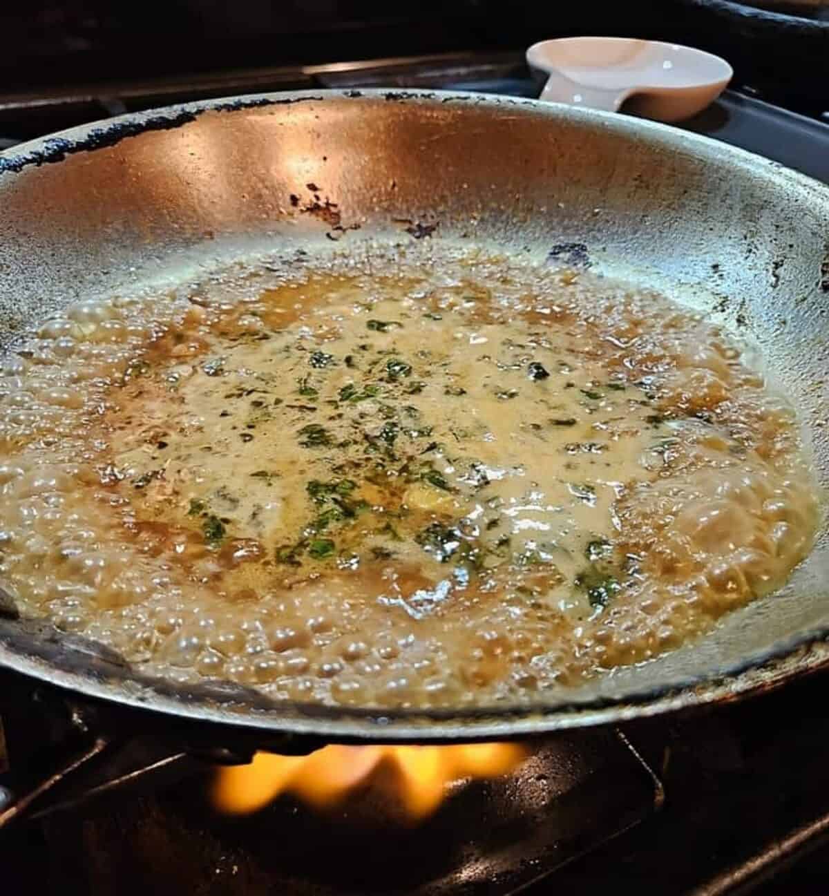sauce bubbling in a skillet.