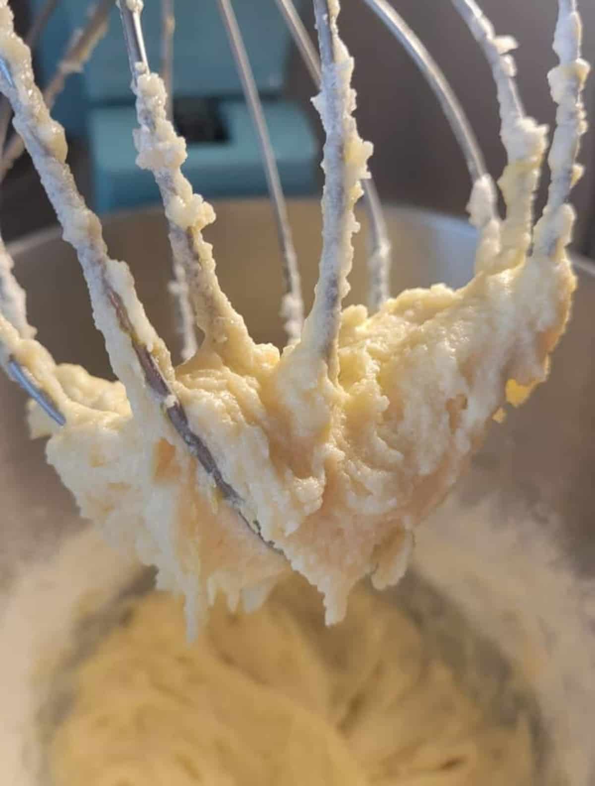 close up of whip attachment, showing mixed batter