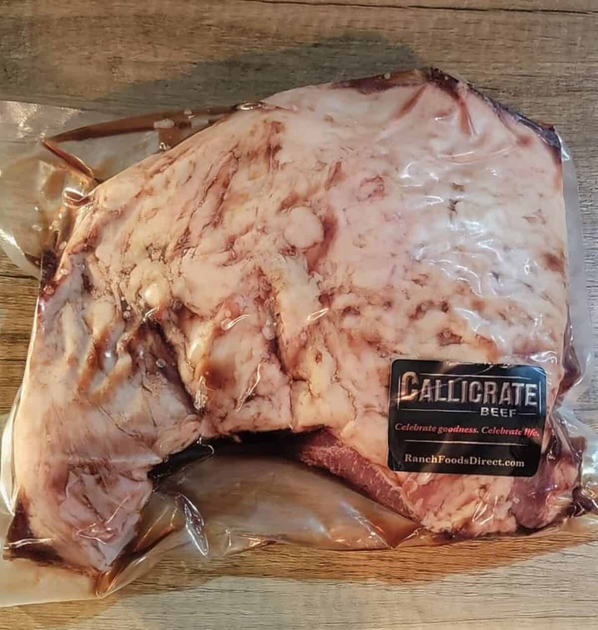 plastic wrapped tri tip, raw, labelled as Callicrate brand