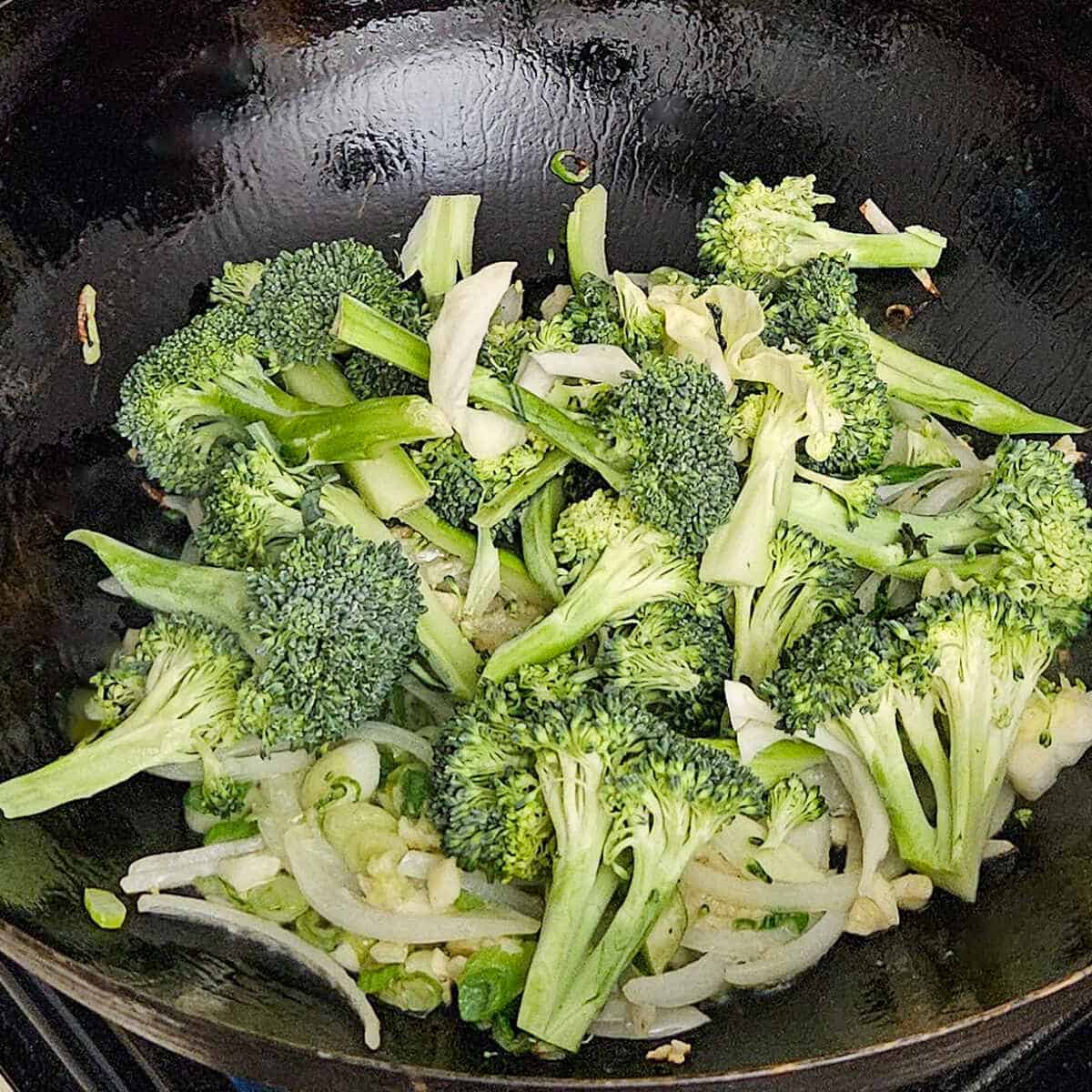 cooking the broccoli in the wok for the easy Asian vegetable stir fry rice noodles recipe