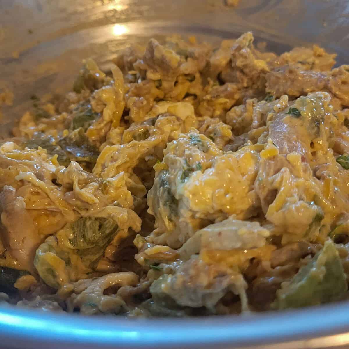 the filling for the chicken enchilada casserole mixed up in a bowl