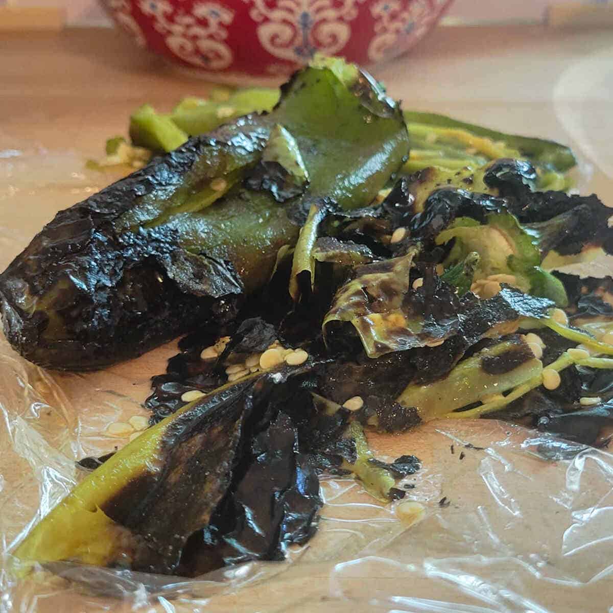 peeling the roasted green chiles for the chicken enchilada casserole