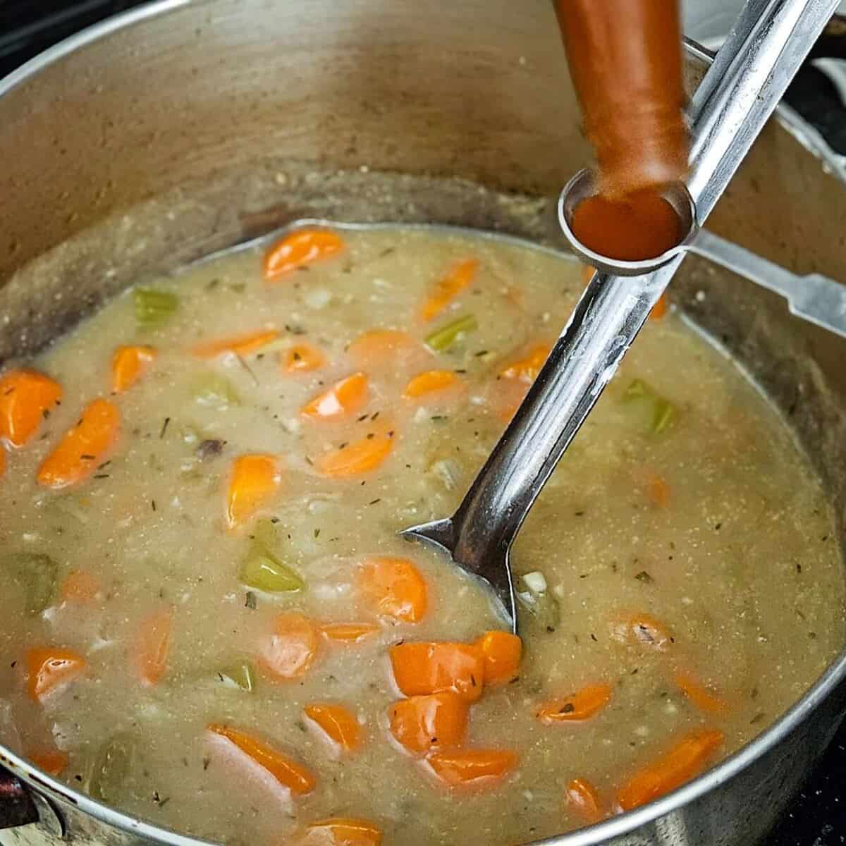 an image of adding hot sauce to the filling for chicken cottage pie