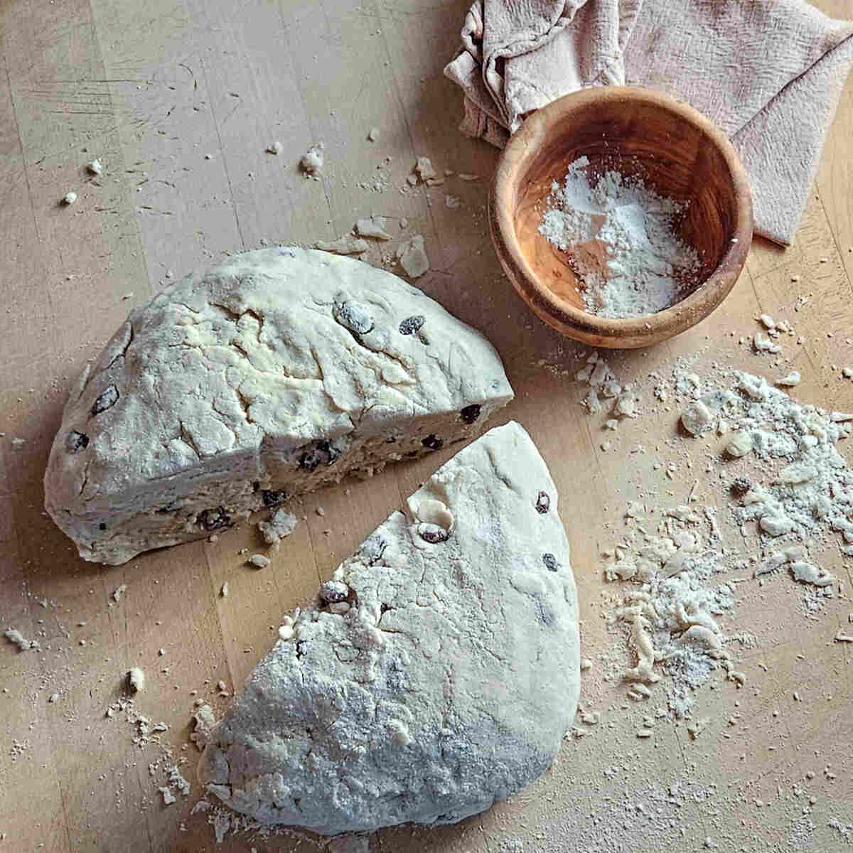 an image of cutting the formed dough in half to make to loaves of gluten free Irish soda bread