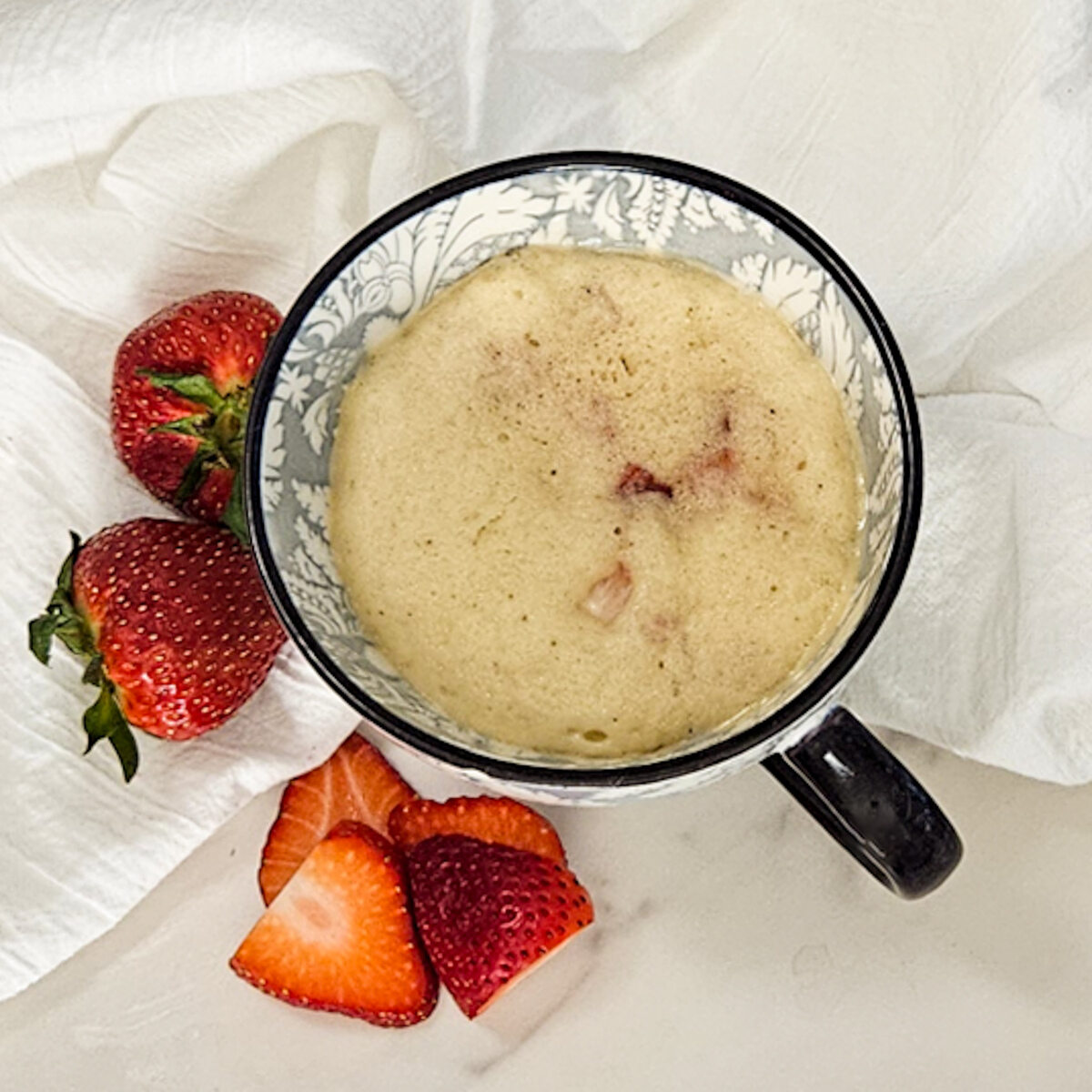 Strawberry mug cake in a mug without the cream.