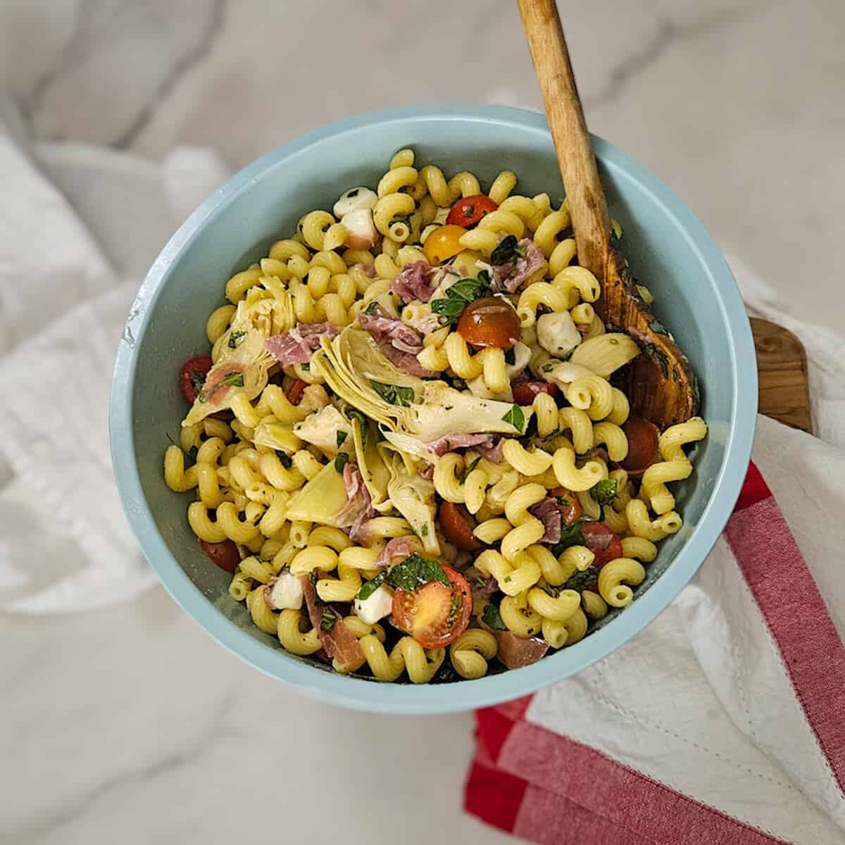 Pasta salad with prosciutto and artichokes.