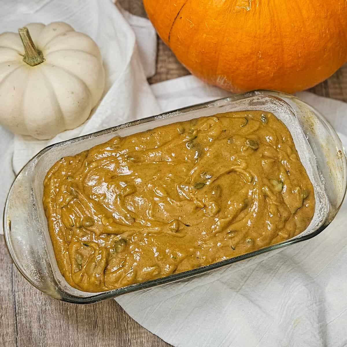 Pumpkin spice zucchini bread batter in a loaf pan ready for the oven.