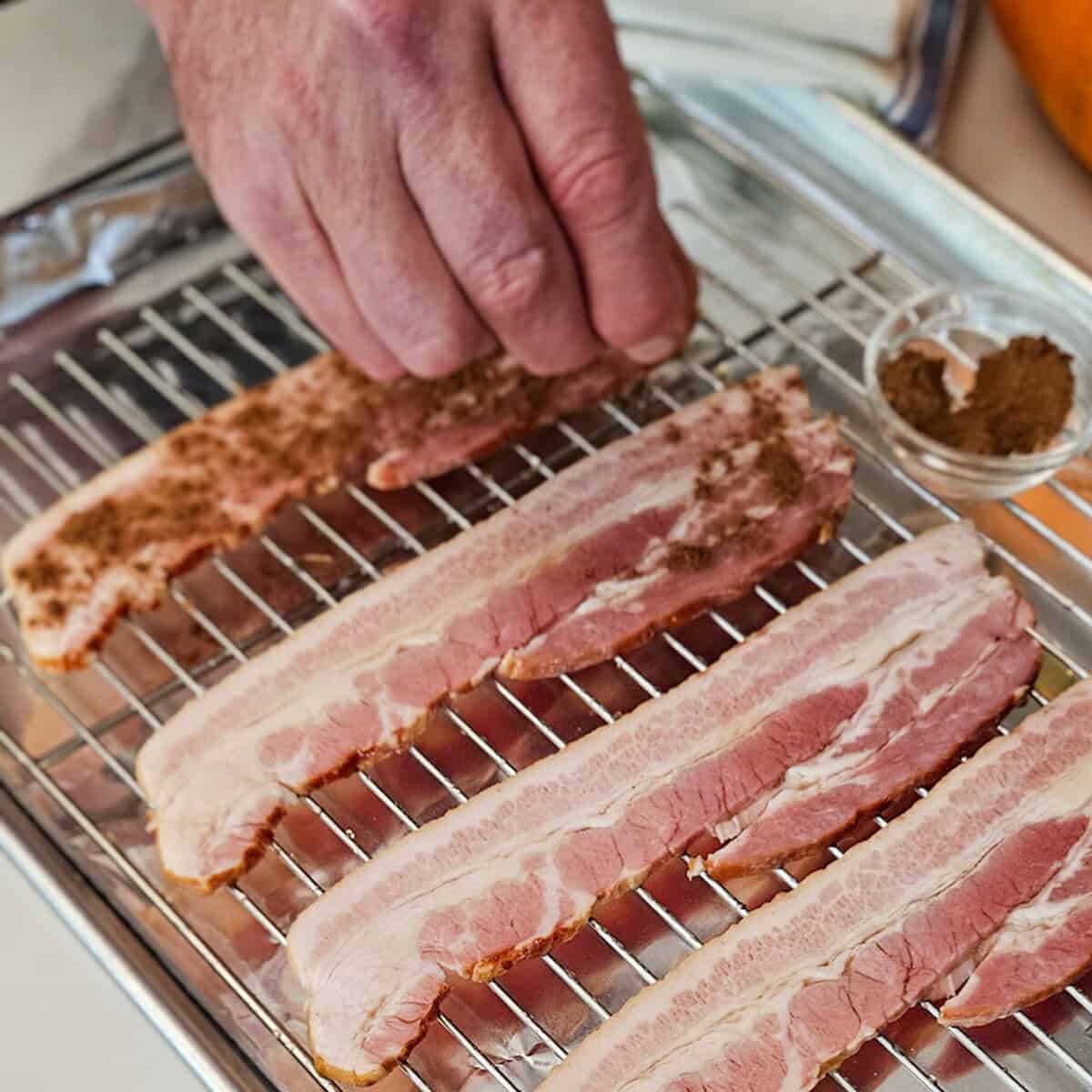 Succulent bacon slices on grate pumpkin spices for flavor.