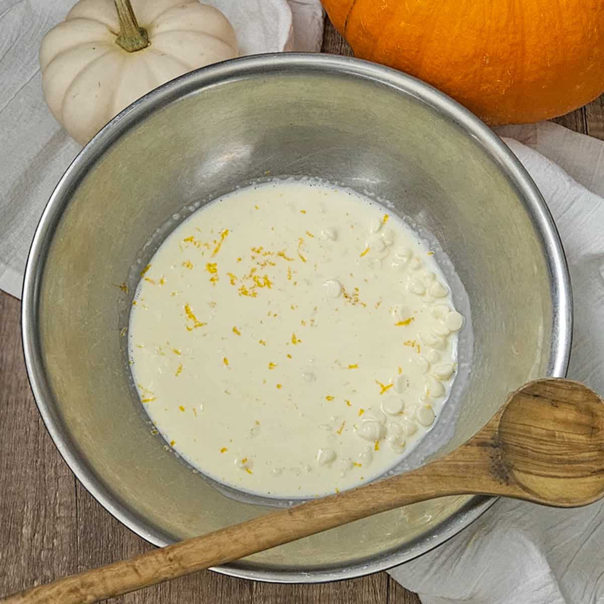 White chocolate ganache in a bowl for the pumpkin spice zucchini bread.