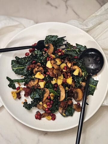 Succulent kale salad with mushrooms and pomegranate seeds, perfect for Season Two Taste culinary experience.