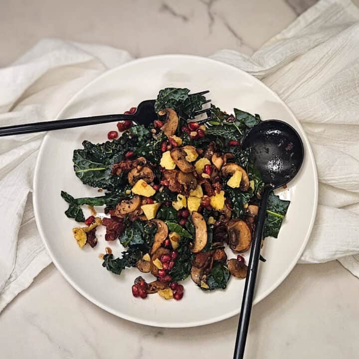 Succulent kale salad with mushrooms and pomegranate seeds, perfect for Season Two Taste culinary experience.