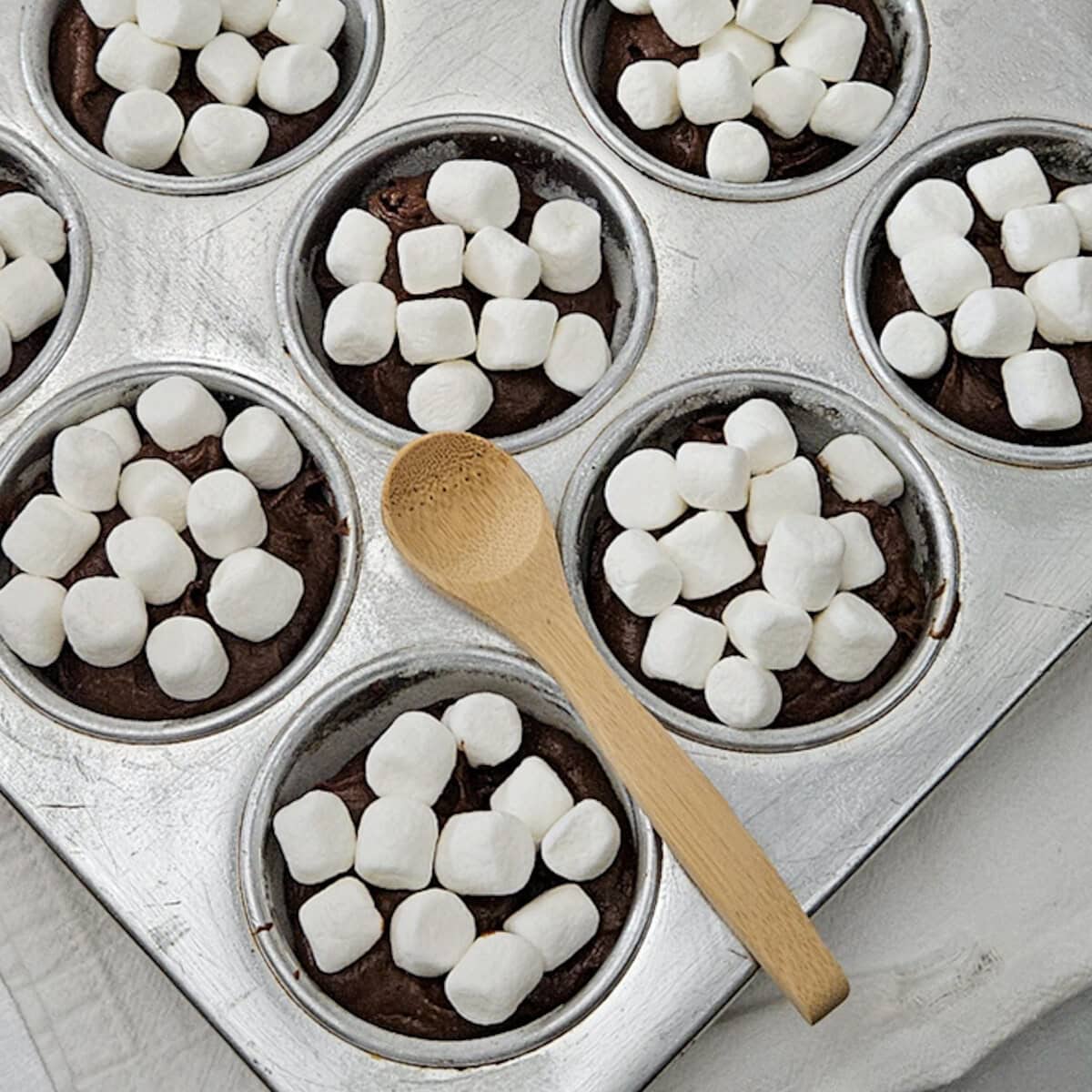 Marshmallows topping rich hot chocolate brownies in individual servings. Perfect cozy dessert for fall or winter.