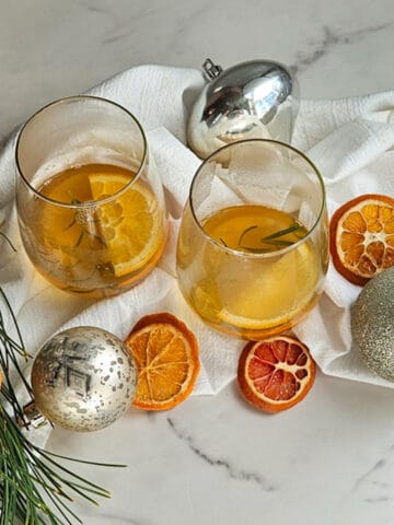 Mulled wine in glasses with orange slices. sliced dried oranges and Christmas decorations.