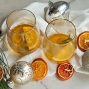 Bright citrus-infused beverages with fresh oranges and herbs, perfect for seasonal celebrations.