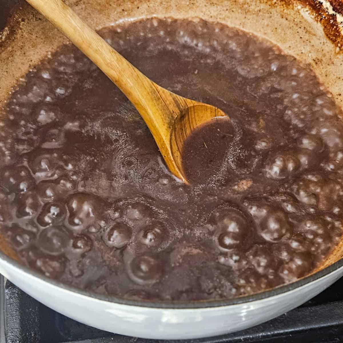 Reducing the red wine sauce for pot roast.