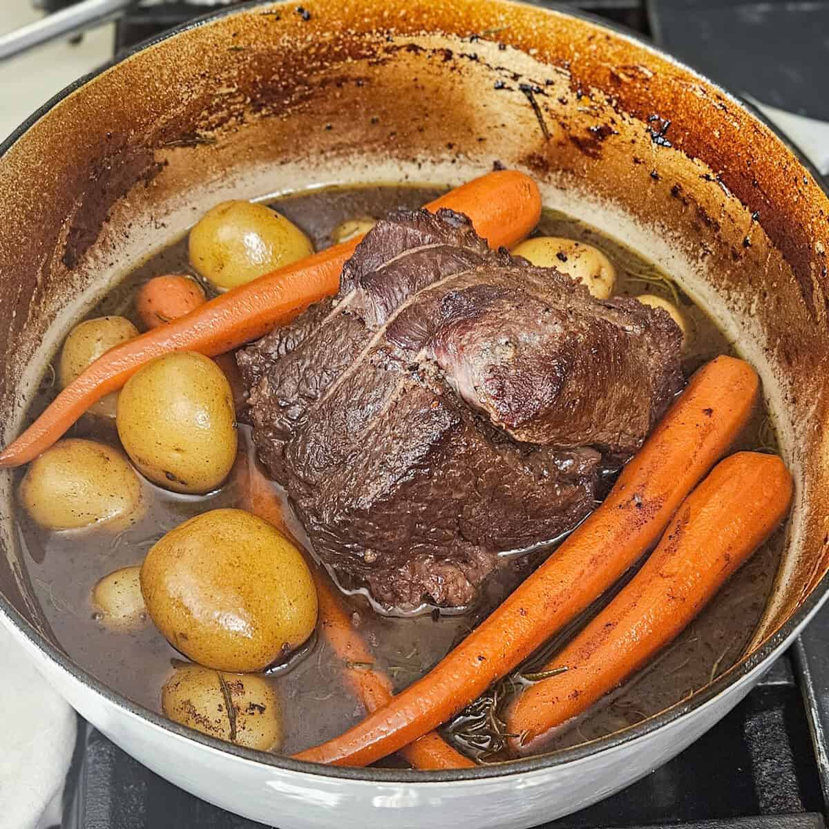 A close-up of a delicious slow-cooked pot roast with vegetables, highlighting hearty flavors and tender meat.