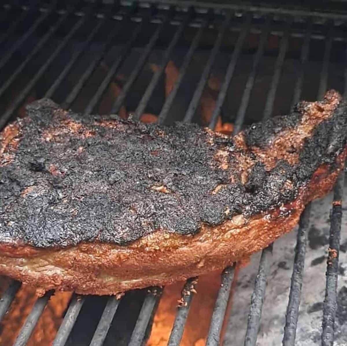 Smoked tri tip beef roast on a grill.