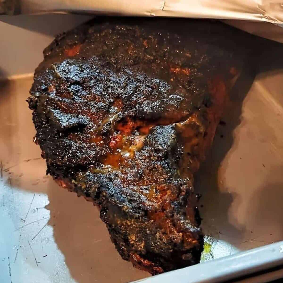 Smoked tri tip beef roast resting in foil.