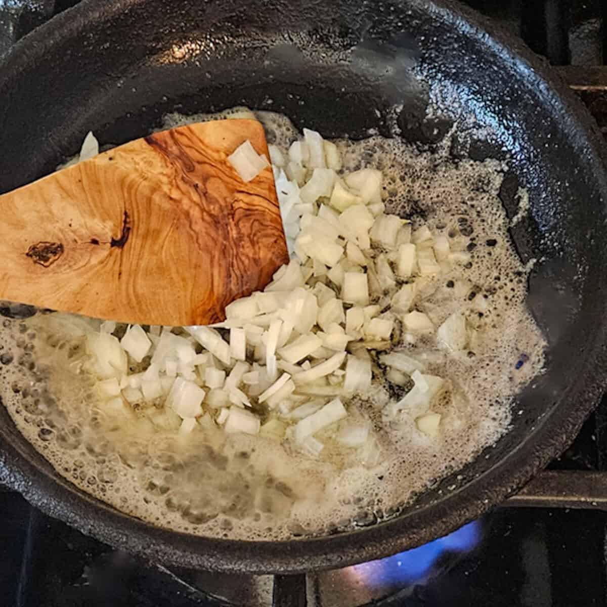 Cooking onions in a skillet with butter.