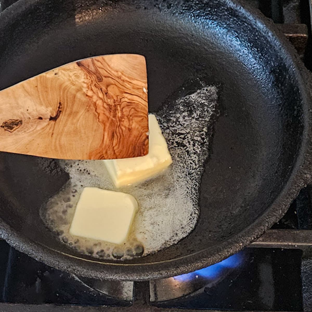 Butter melting in a skillet for cooking.