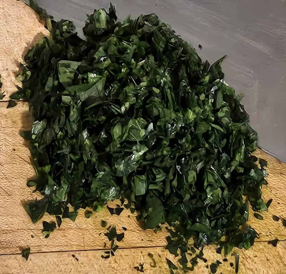 Chopped fresh parsley with a knife alongside.